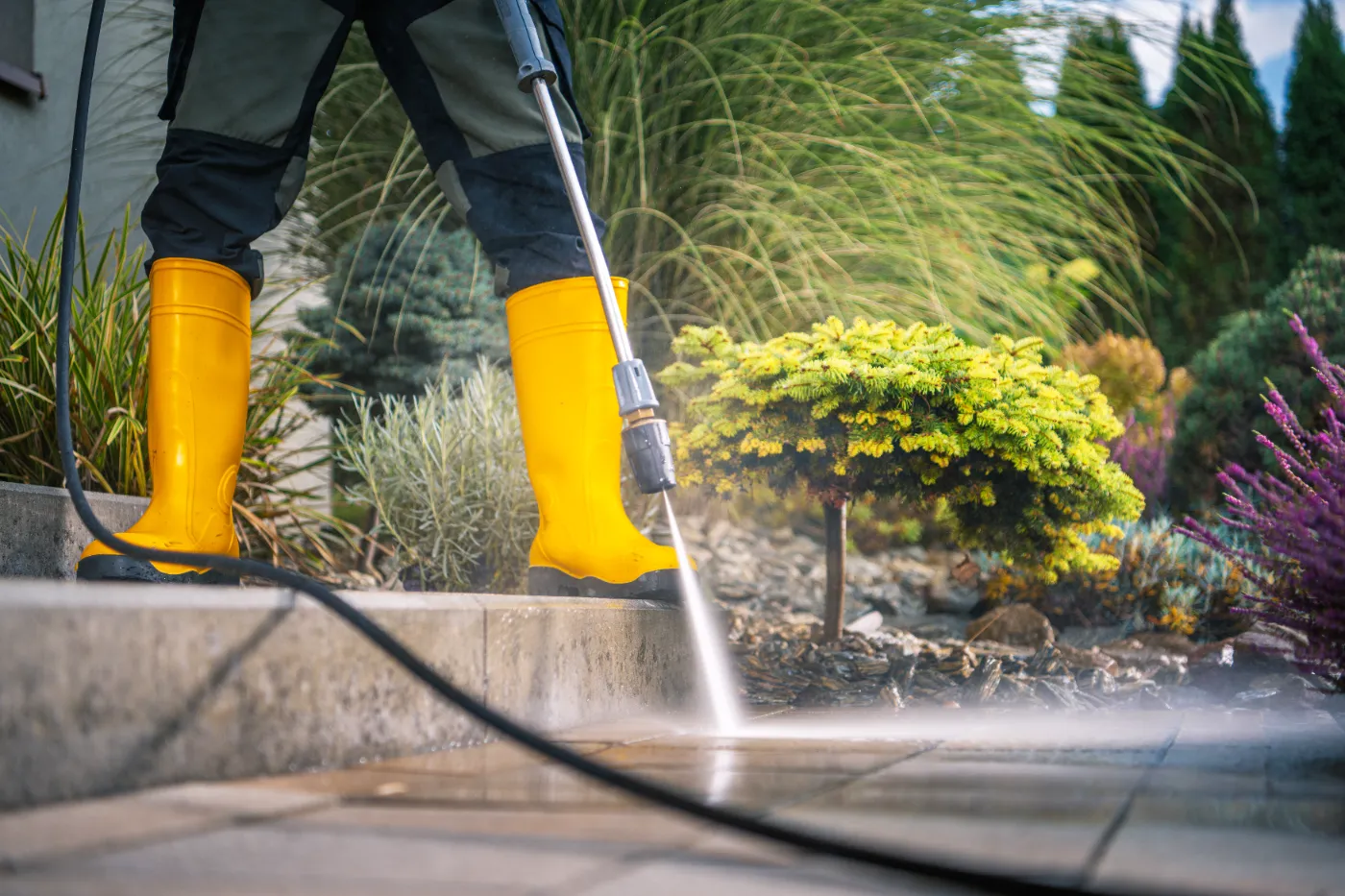 A man servicing a cleaning service on the client's patio.